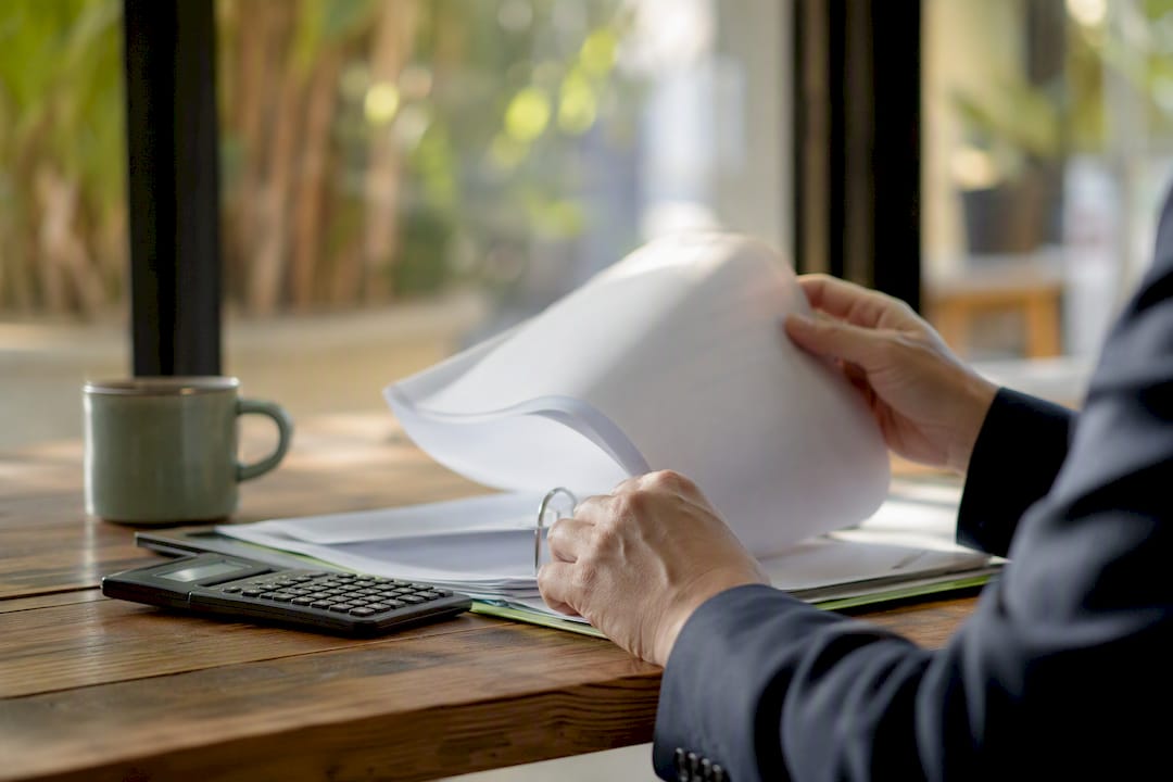 Hands examining credit report pages